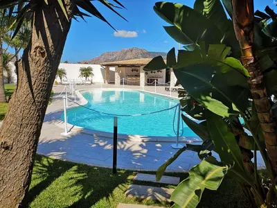 a pool with a swing in a yard at Villa Araucaria in Partinico