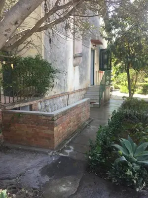 a house with a brick bench in front of it at Villa Serrano in Palermo