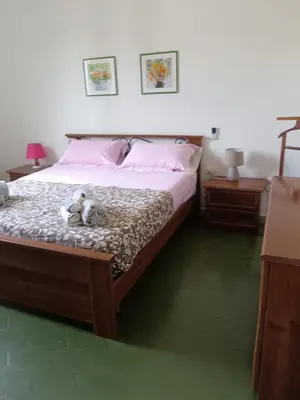 a bedroom with a bed with two stuffed animals on it at Villa Serrano in Palermo