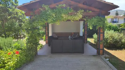 a pergola with a desk in a garden at Villa Serrano in Palermo