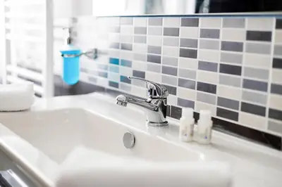a bathroom sink with a faucet and two soap bottles at La Querencia in Palermo