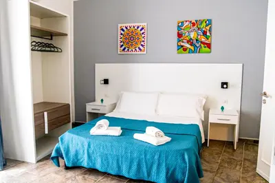 a bedroom with a bed with two towels on it at La Querencia in Palermo