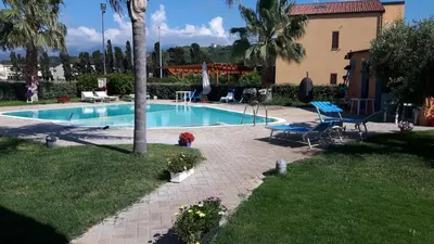 a swimming pool in a yard next to a house at Beb oasi marina in Campofelice di Roccella