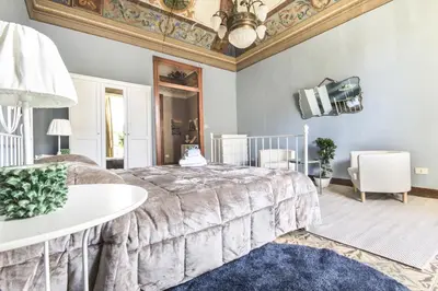 a bedroom with a large bed and a ceiling at SUITE S.LUCIA in Corleone