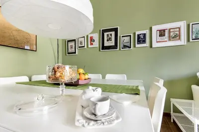 a dining room with a white table with a white lamp at SUITE S.LUCIA in Corleone
