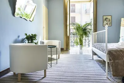a bedroom with a bed and a crib and a table at SUITE S.LUCIA in Corleone