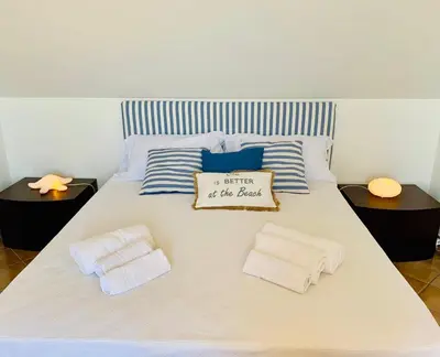 a bed with two towels and a pillow on it at Casa Mandarino in Macari