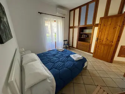 a bedroom with a bed with a blue comforter at Da Sophie in Mondello