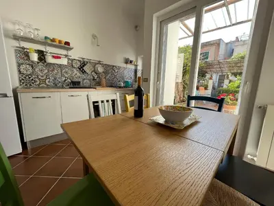 a kitchen with a wooden table with a bowl of food on it at Da Sophie in Mondello