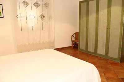 a bedroom with a bed and a glass door at Villa Porto Rais in Carini