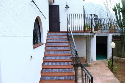 a stairway with blue and white tiles on a house at Villa Porto Rais in Carini