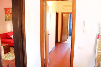 a hallway with a room with a red couch at Villa Porto Rais in Carini