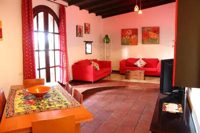 a living room with red couches and a table at Villa Porto Rais in Carini