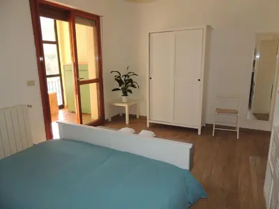 a bedroom with a blue bed and a mirror at La Locanda del Cedro in Palermo