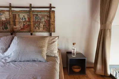 a bedroom with a bed and a painting on the wall at Casa Saleiman in Castellammare del Golfo