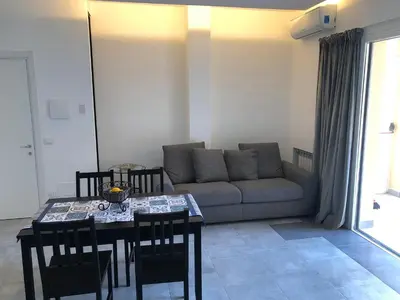 a living room with a couch and a table and chairs at Residenza De Gasperi in Palermo