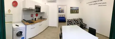 a kitchen with a washer and dryer in a room at Casa Saline in Mondello