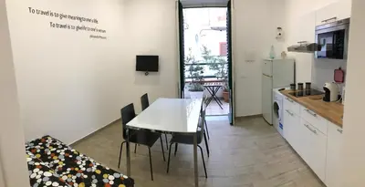 a kitchen and dining room with a white table and chairs at Casa Saline in Mondello