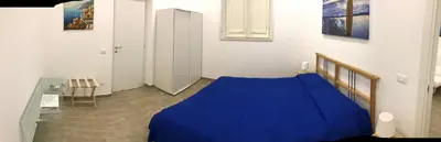 a bedroom with a blue bed in a room at Casa Saline in Mondello