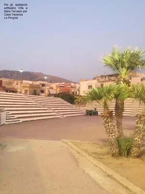a large amphitheater with palm trees and buildings at Casa Vacanza La Pergola in Terrasini
