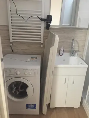 a laundry room with a washing machine and a sink at Casa Vacanze La Pergola@ in Terrasini