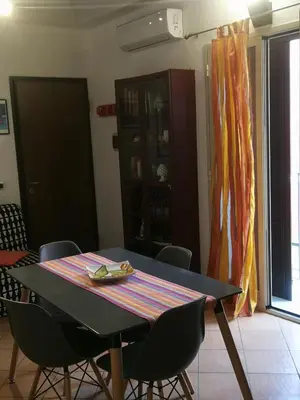 a dining room table with chairs in a room at Stranizza d'amuri, al Capo vero cuore di Palermo vedi anche atocà1 in Palermo