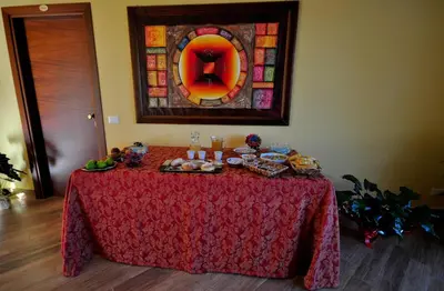 a table with food on it with a stained glass window at Al Cantuccio in Castelluzzo