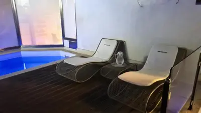 two white chairs and a vase on a bowling alley at Quintocanto Hotel & Spa in Palermo