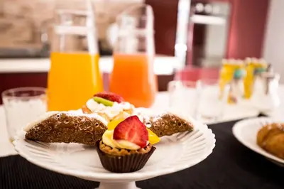 a white plate with two pastries on a table at La Casa del Moro in Palermo