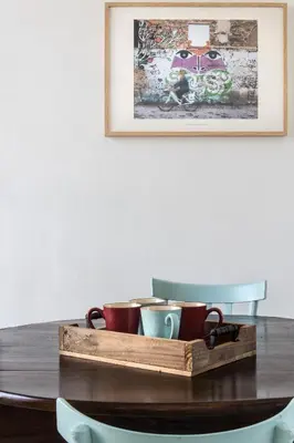 a tray of coffee cups on a table with a picture at Palazzo Castrofilippo Apartment by Wonderful Italy in Palermo