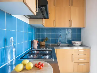 a blue tiled kitchen with a counter with fruit on it at Palazzo Castrofilippo Apartment by Wonderful Italy in Palermo