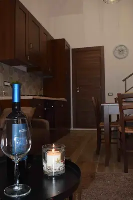 a bottle of wine and a candle on a table at Casa Vacanza Mar' illù in Castellammare del Golfo