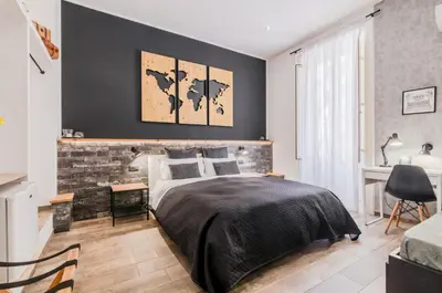 a bedroom with a bed and a brick wall at Panurban Rooms by Wonderful Italy in Palermo