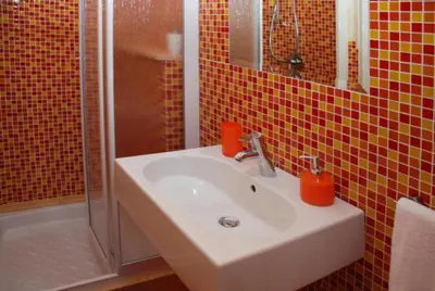 a bathroom with a sink and a shower at Angolo Arancio Bed & Breakfast in San Vito lo Capo