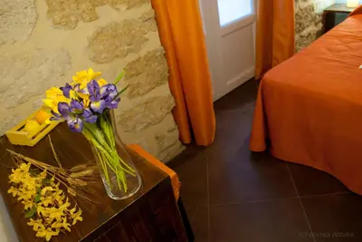 a vase of flowers on a table in a room at Affittacamere B&B Carella in Palermo