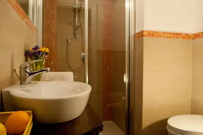 a bathroom with a sink and a shower and a toilet at Affittacamere B&B Carella in Palermo
