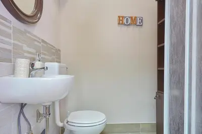 a bathroom with a white toilet and a sink at Sturzo 44 in Palermo