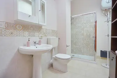 a bathroom with a toilet and a sink and a shower at Sturzo 44 in Palermo