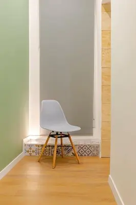 a white chair sitting in an empty room at Alle Antiche Mura del mercato di Ballarò in Palermo