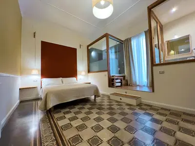 a bedroom with a bed and a large mirror at Bed in Spa in Palermo