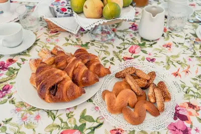 a table with two plates of pastries and bread at B&B Elvira Al Duomo in Monreale