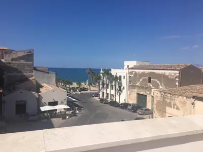 a view of a city street with buildings and cars at Veranda sul Mare in Castellammare del Golfo