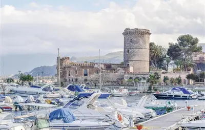 a bunch of boats in a harbor with a castle at Casa Antonio in Mandra Capreria