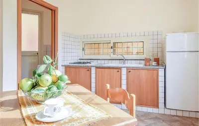 a kitchen with a table with a bowl of fruit on it at Casa Antonio in Mandra Capreria
