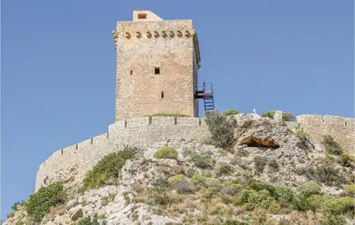 a castle on top of a mountain with a blue sky at Casa Giuseppa in Mandra Capreria