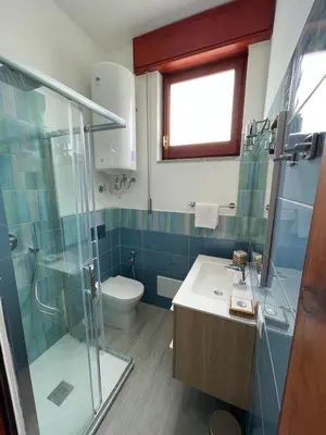 a bathroom with a shower and a sink and a toilet at Sul lungo mare posizione unica in San Vito lo Capo