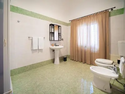 a bathroom with a toilet and a sink at Kalamarina Rooms in Palermo