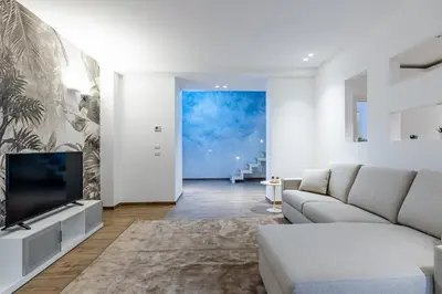 a living room with a couch and a tv at Solemar Sicilia - Galleria Maqueda in Palermo