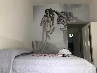 a bedroom with a statue of a man on a bed at Amantea Monument in Terrasini