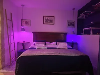 a bedroom with a purple room with a bed at Il Rifugio in Palermo